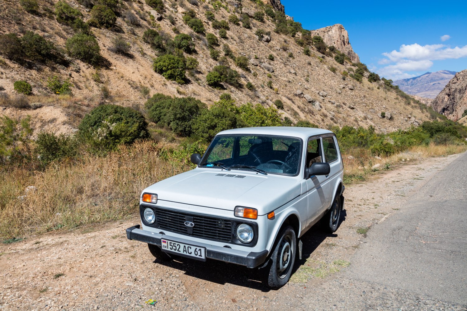 Boxy compact off-road SUV with round headlights and integrated bumpers.
