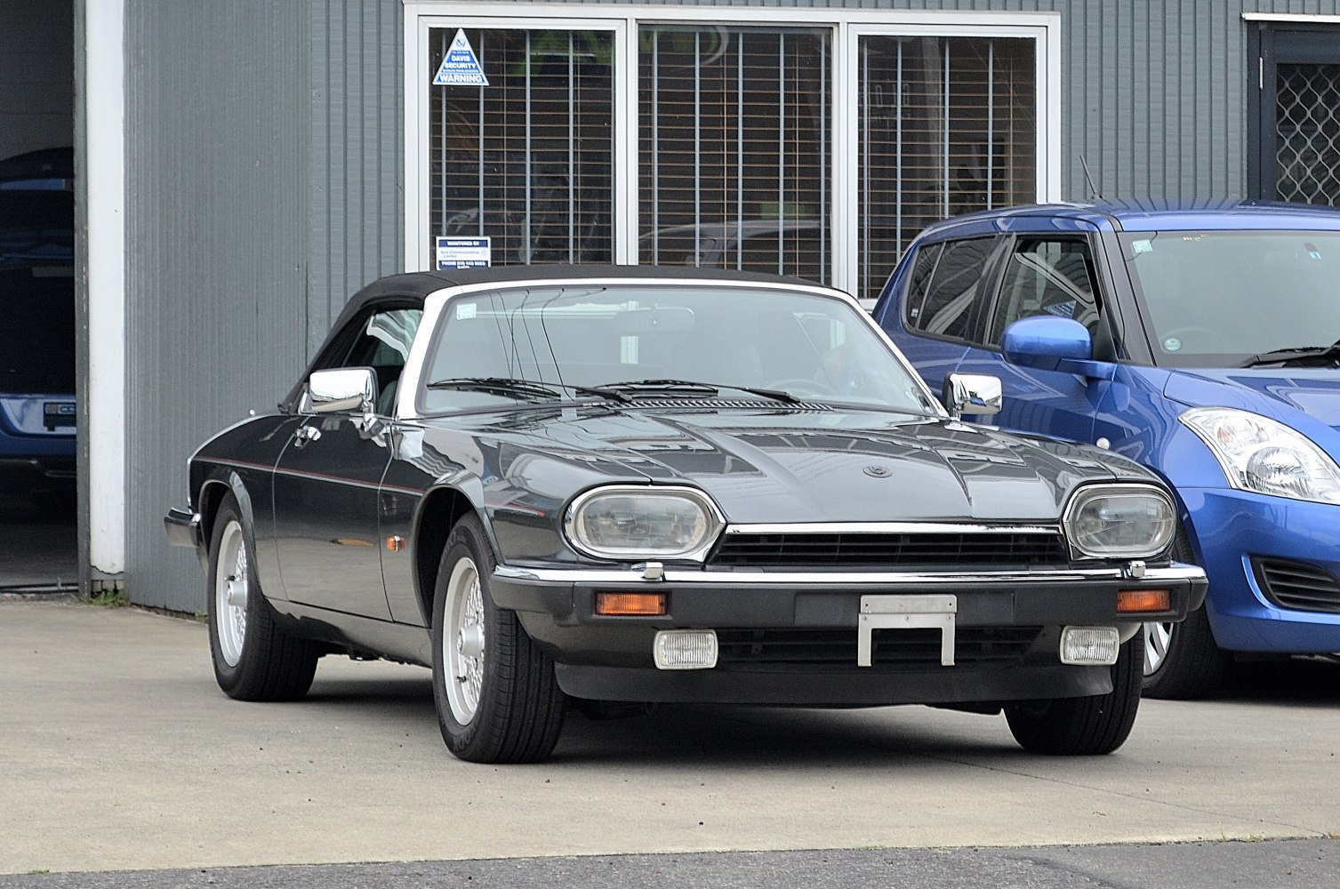 Vintage convertible with rectangular headlights and wire-spoke wheels