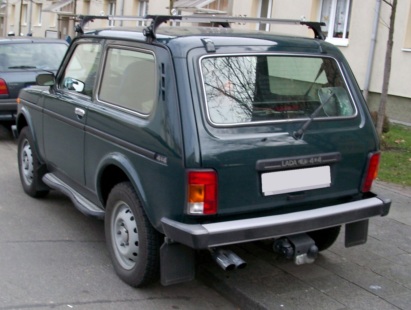 Rear view of 3-door SUV with roof rack and dual exhaust