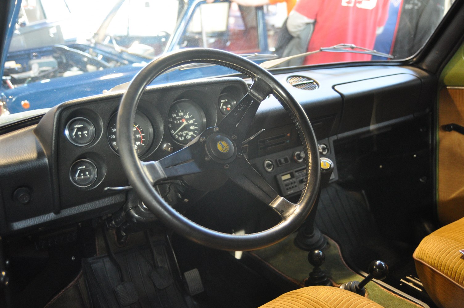 Vintage steering wheel and dashboard with analog gauges and manual controls