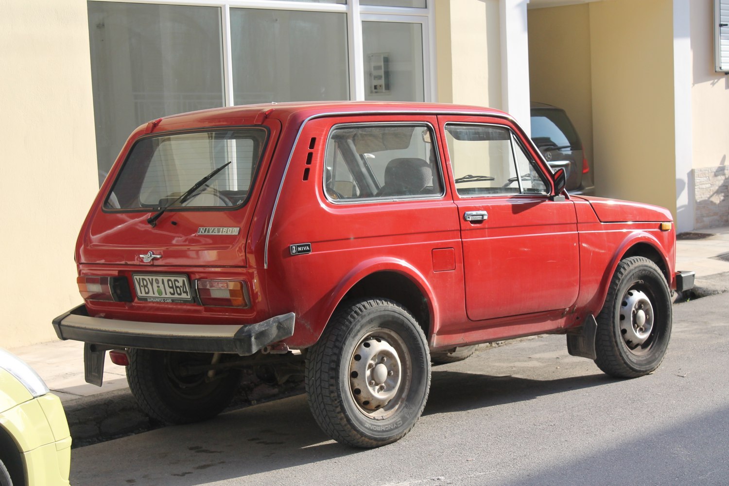Rear and side view of a three-door compact SUV with rugged tires and boxy design