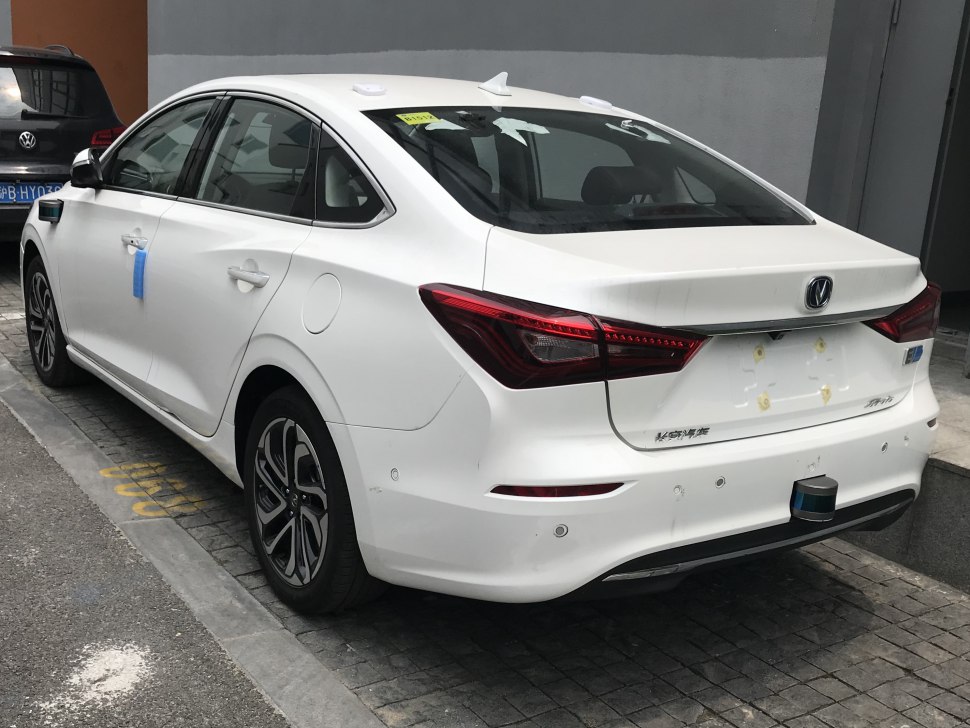 Rear and side profile of white sedan with LED tail lights and alloy wheels