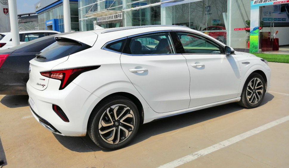 White hatchback side view with sharp rear lights and alloy wheels