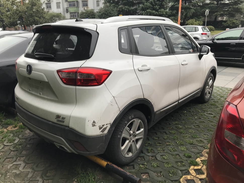 Rear and side view of white compact SUV with taillights and alloy wheels