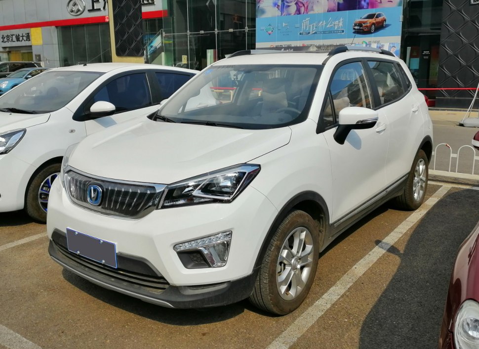 White compact SUV with angular headlights and roof rails