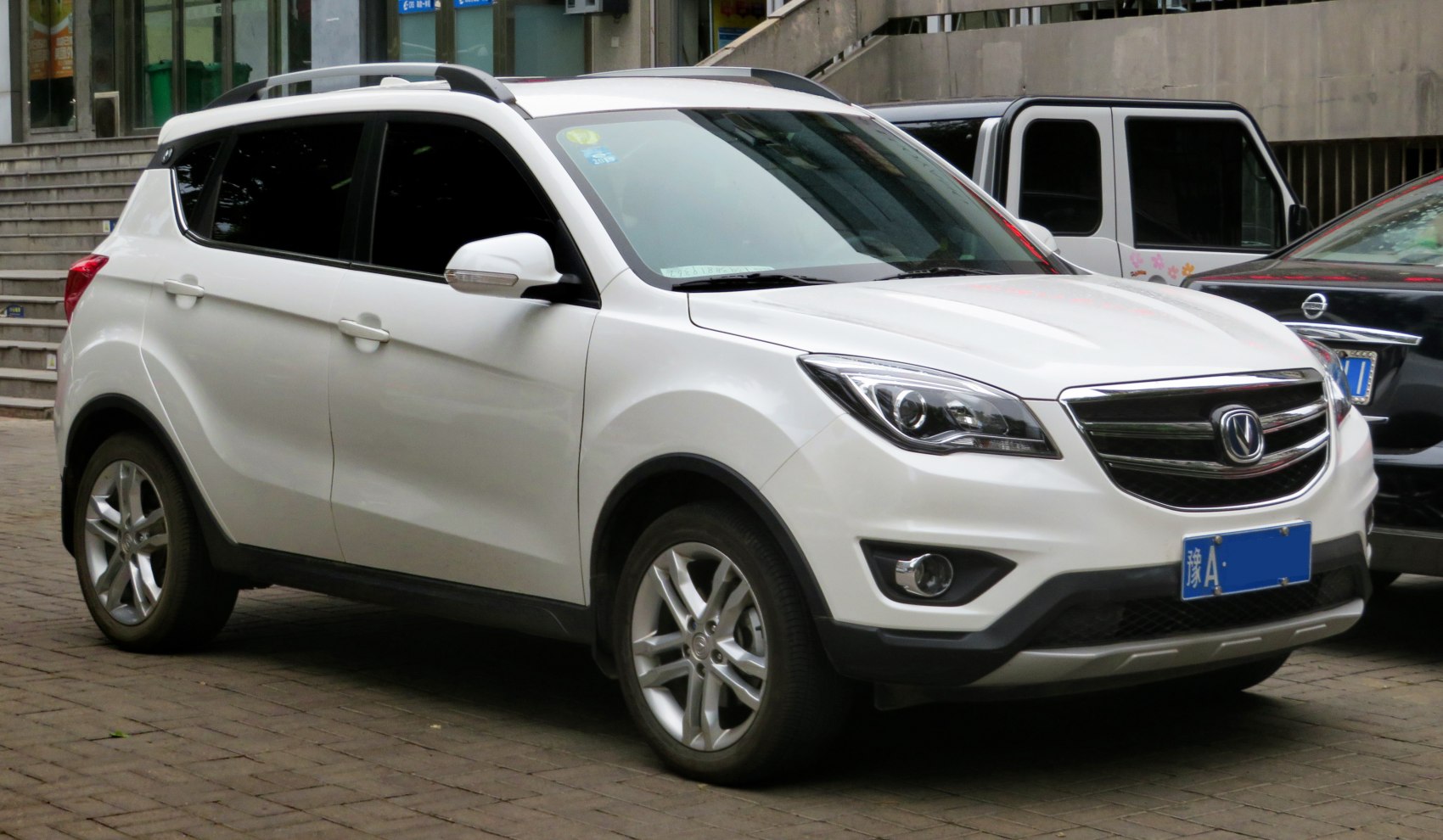 White compact SUV front-side view, sharp headlights, alloy wheels