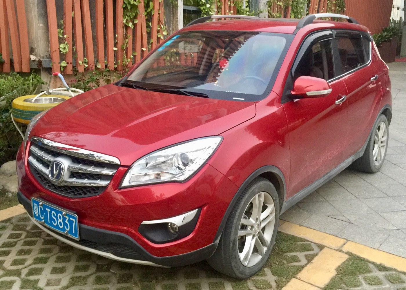 Red compact SUV with distinct front grille and headlight design