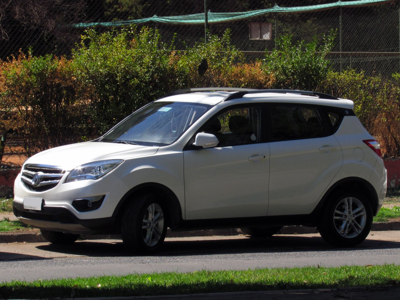 Side view of compact SUV with roof rails and alloy wheels