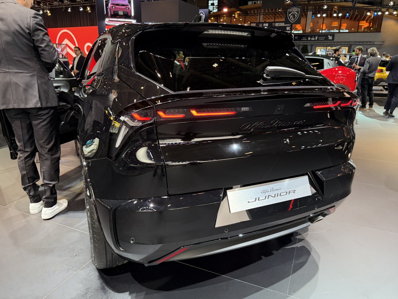 Rear view with sleek LED tail lights and black glossy finish.