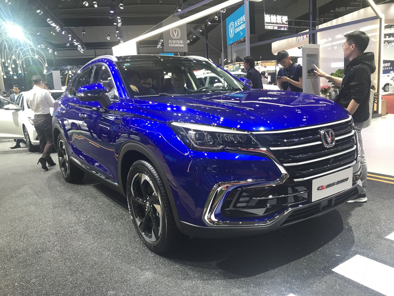 Front-side view of blue SUV with LED headlights and chrome grille