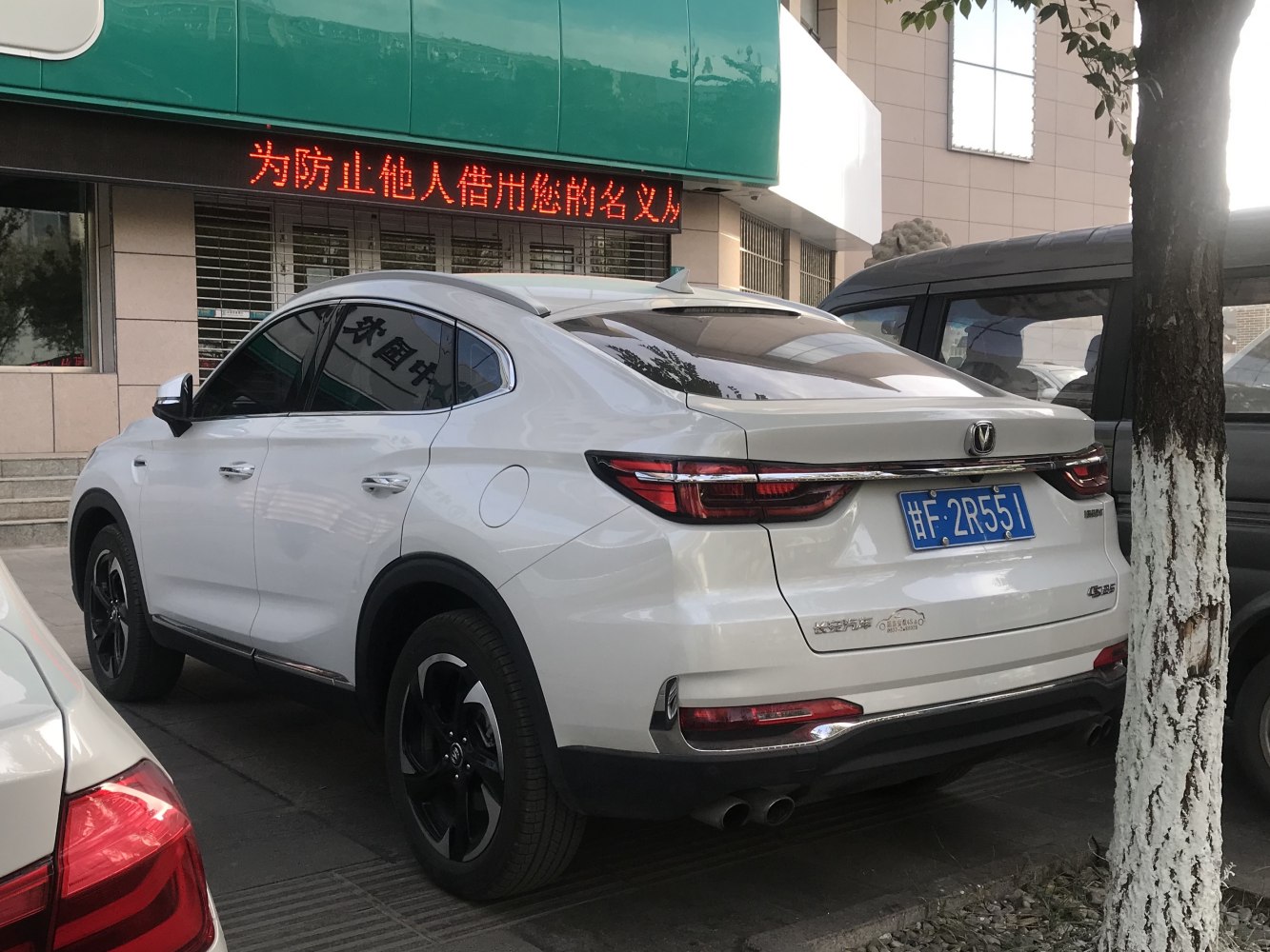 Rear side view with LED taillights, dual exhausts, and black alloy wheels