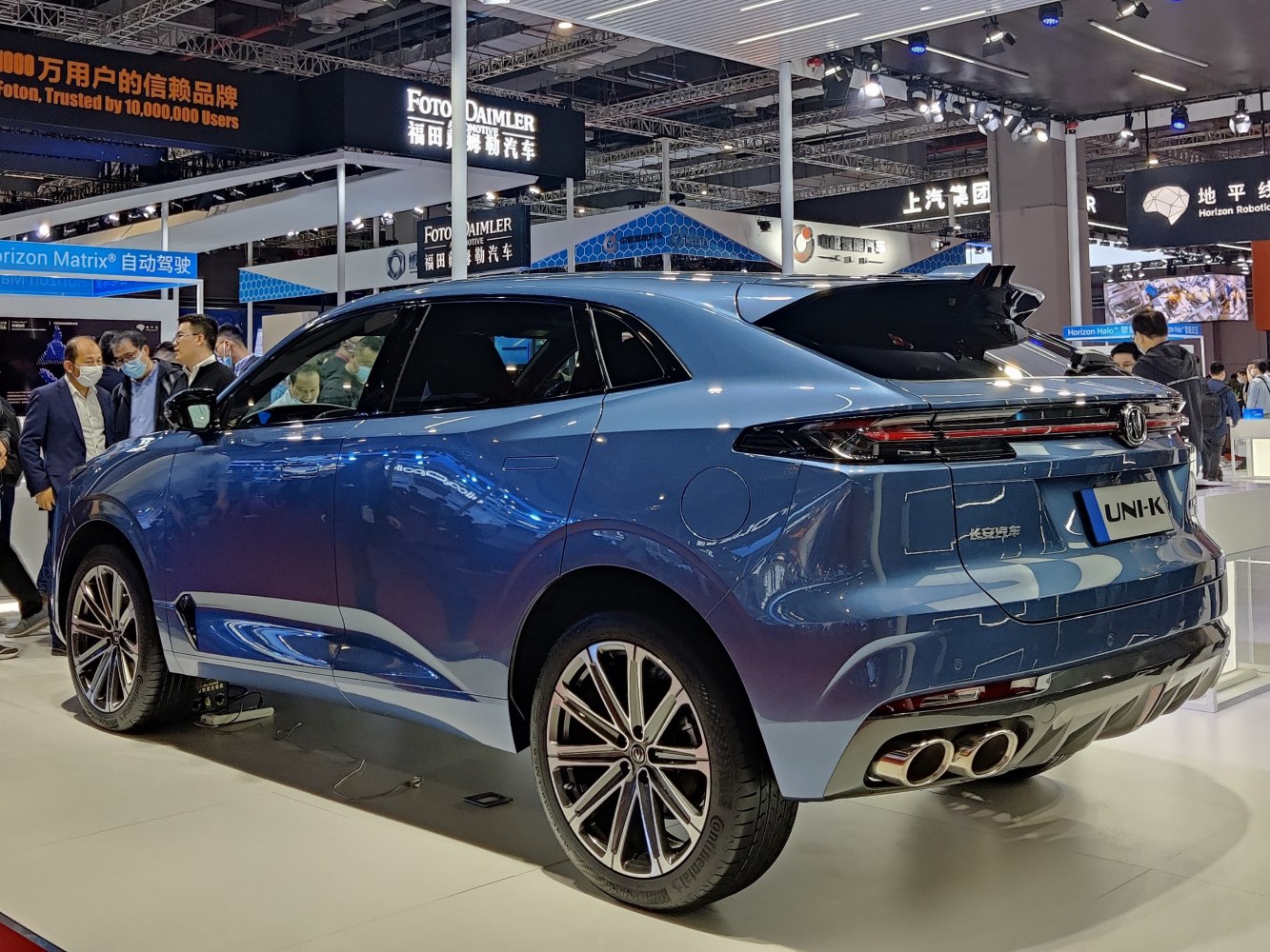 Rear view of a blue SUV with quad exhaust and sleek design.