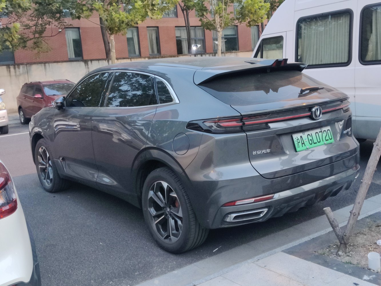 Rear three-quarter view of a sporty SUV with distinct tail lights and dual exhausts