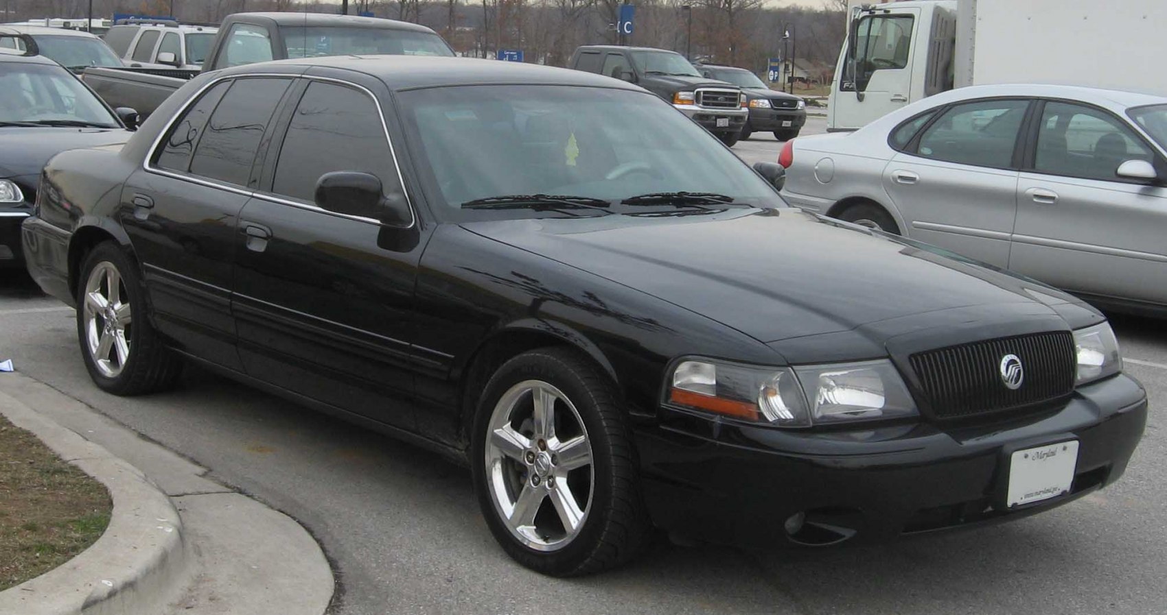 Black luxury sedan with sporty chrome wheels and tinted windows