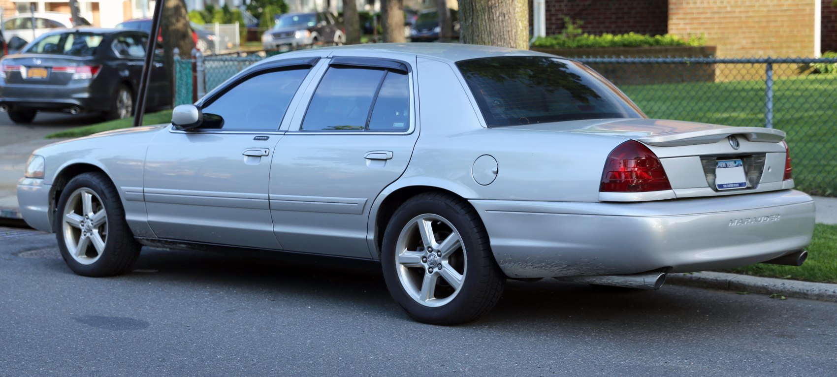 Rear side profile with alloy wheels and rear spoiler