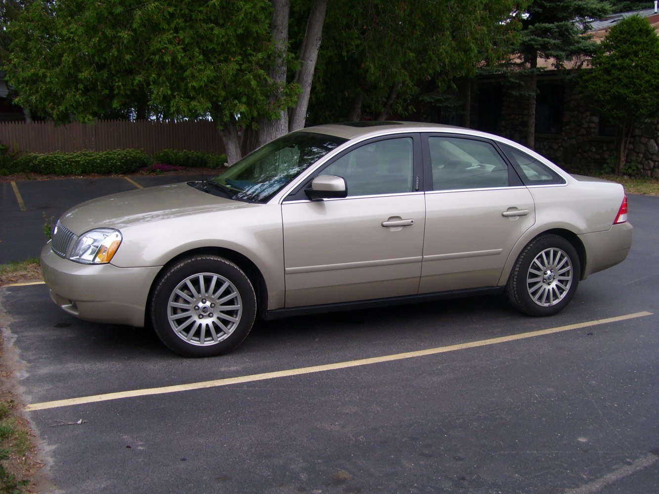 Side profile of sedan with alloy wheels and sunroof