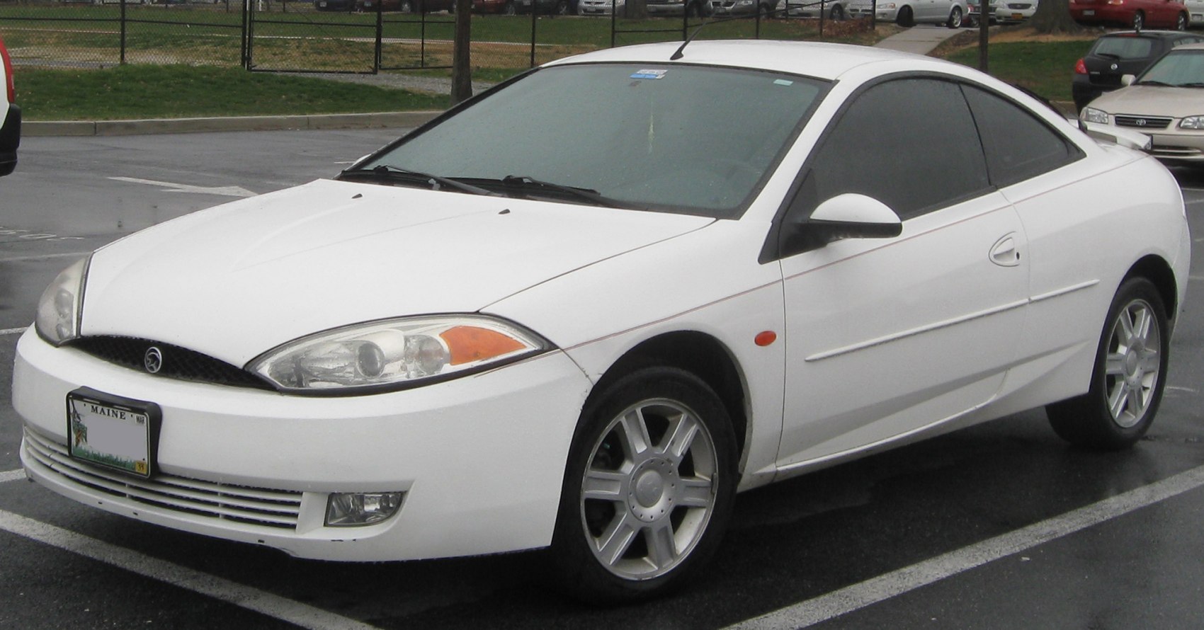 White sporty 2-door coupe with tinted windows and aerodynamic front end