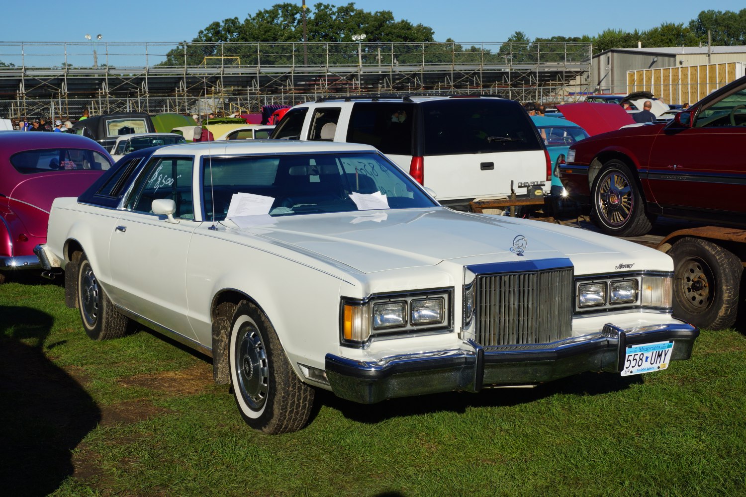 White vintage coupe with bold front grille and two-door design