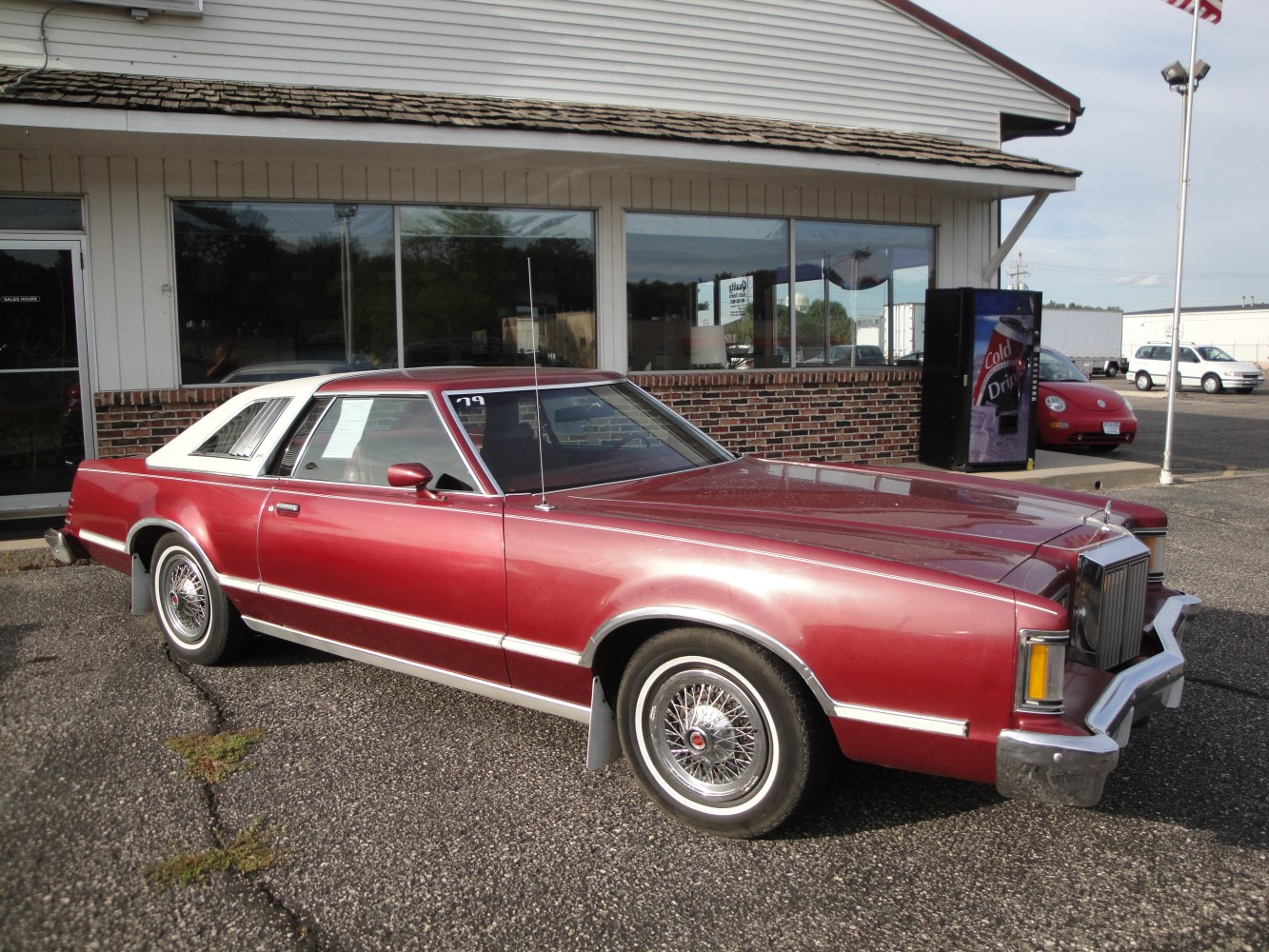 Vintage coupe with vinyl roof and wire-spoke wheels