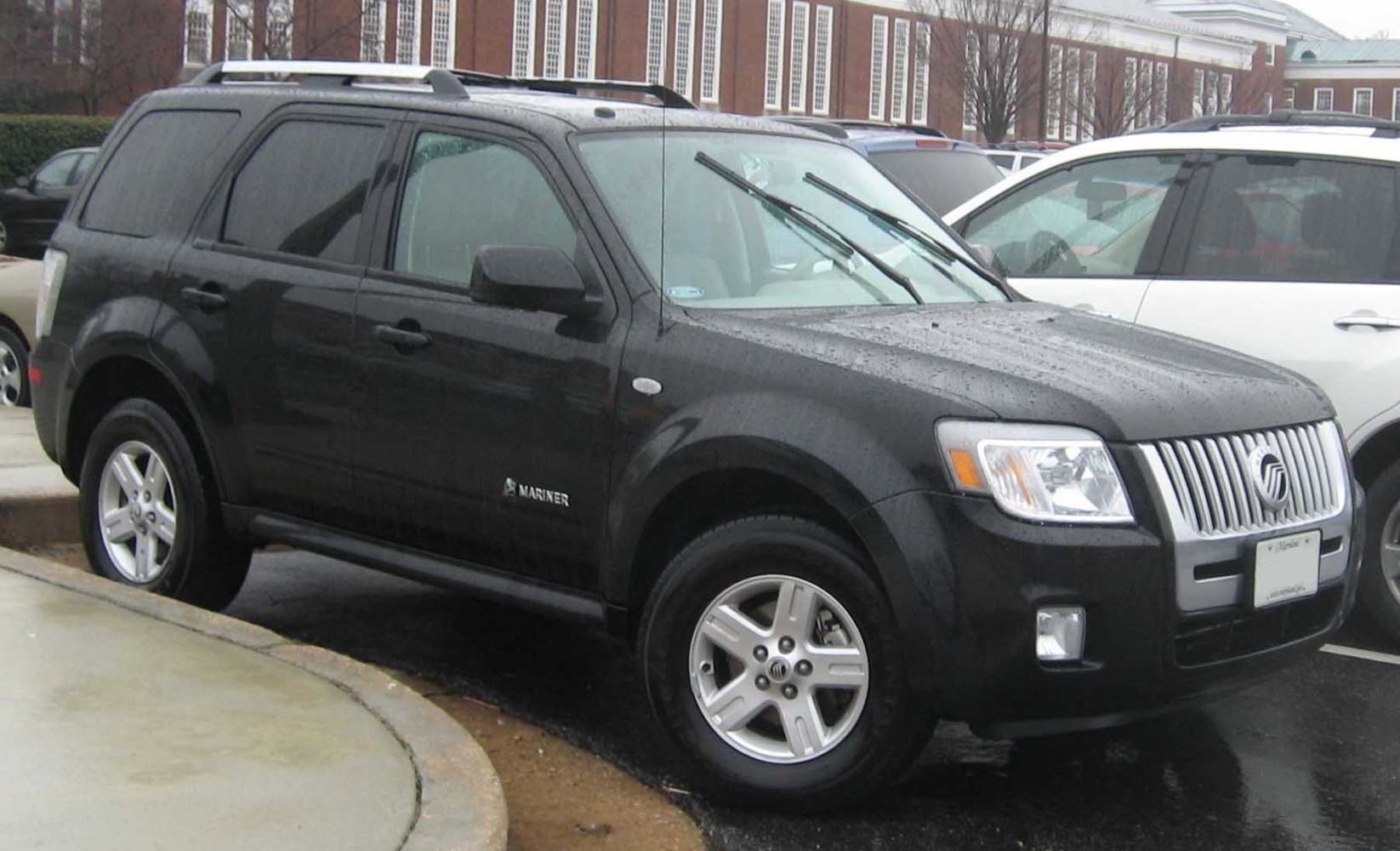 SUV with prominent front grille and roof rails in black paint.