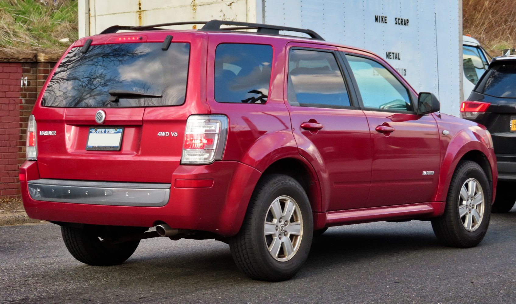 Red SUV rear view with 4WD V6 and distinct rear quarter design