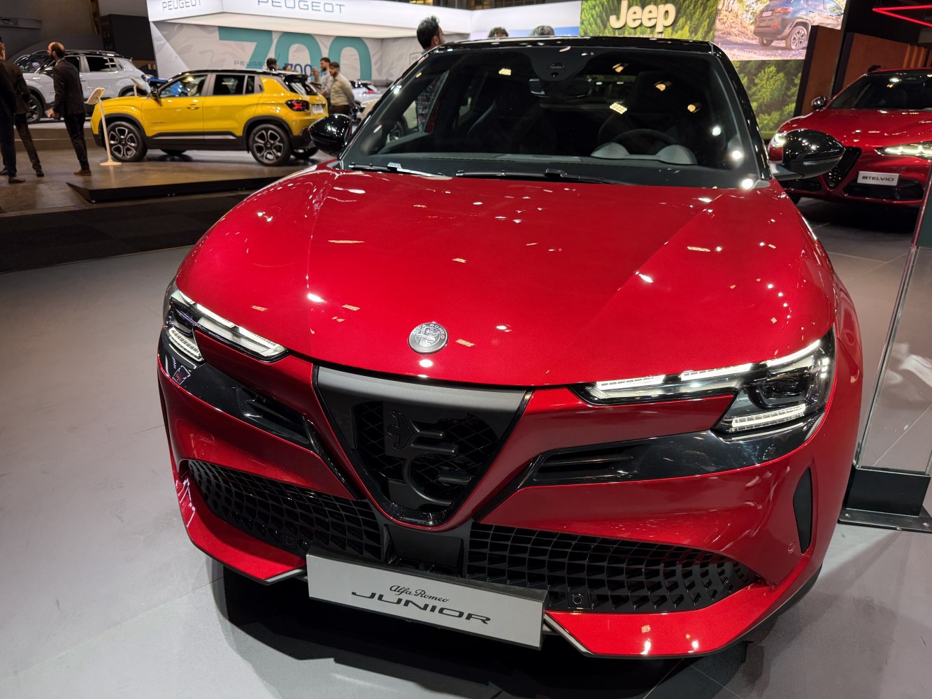 Close-up of a car front with LED headlights and bold grille.