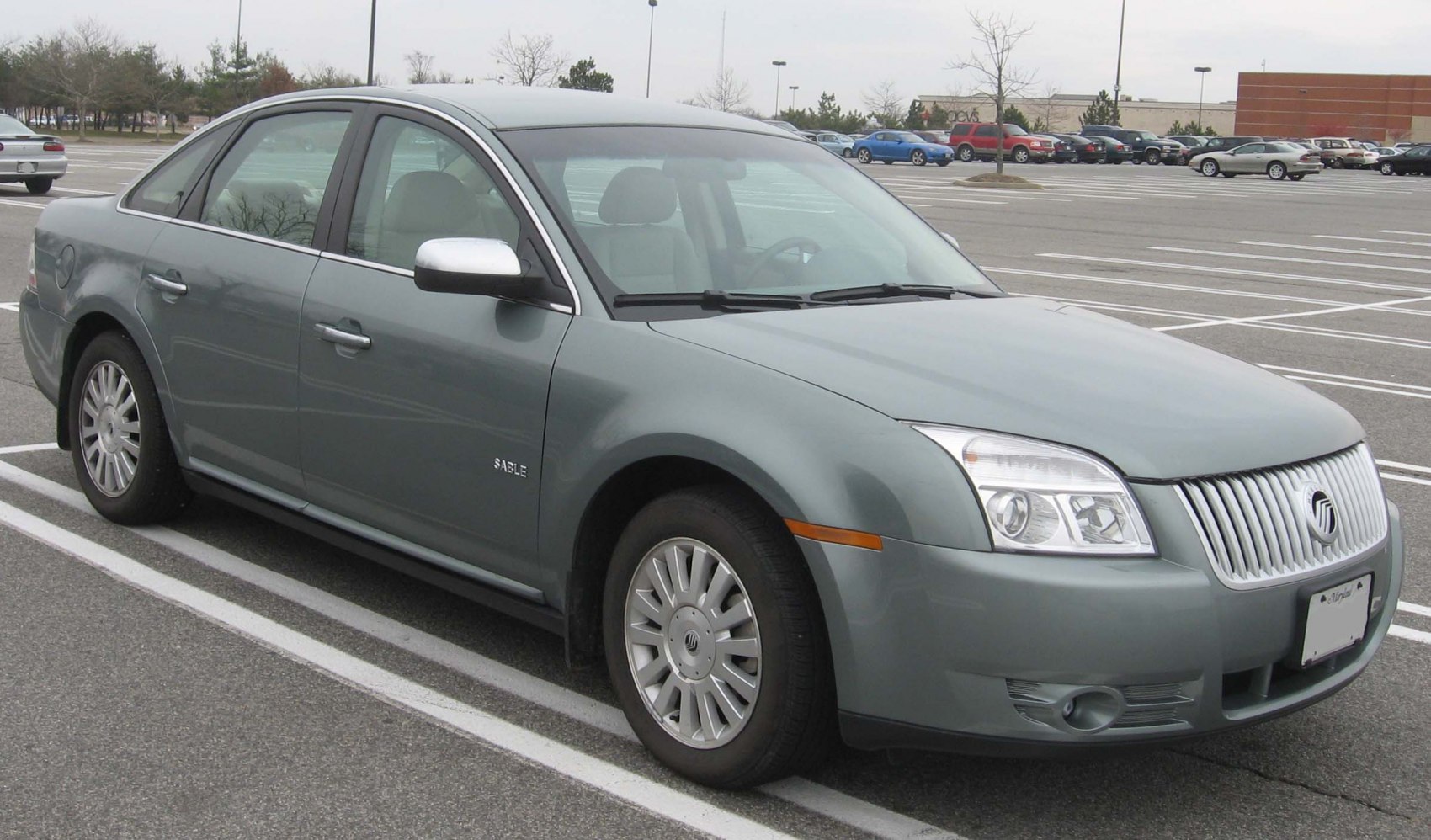 Front side view of a mid-size sedan with vertical grille and clear headlights