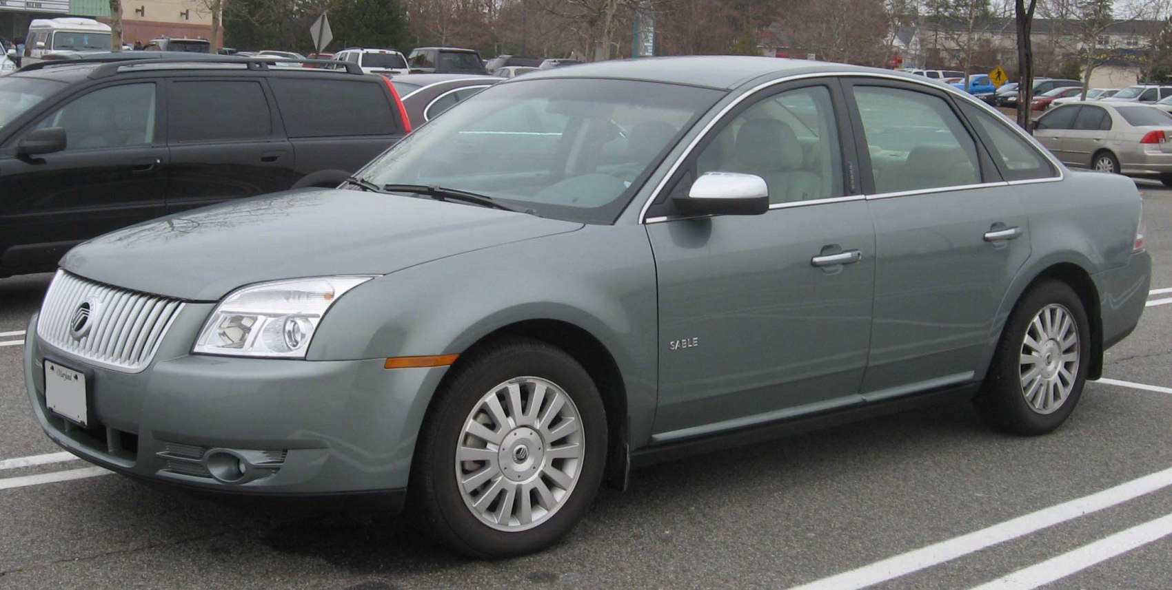 Front-side view of sedan with distinctive grille and alloy wheels