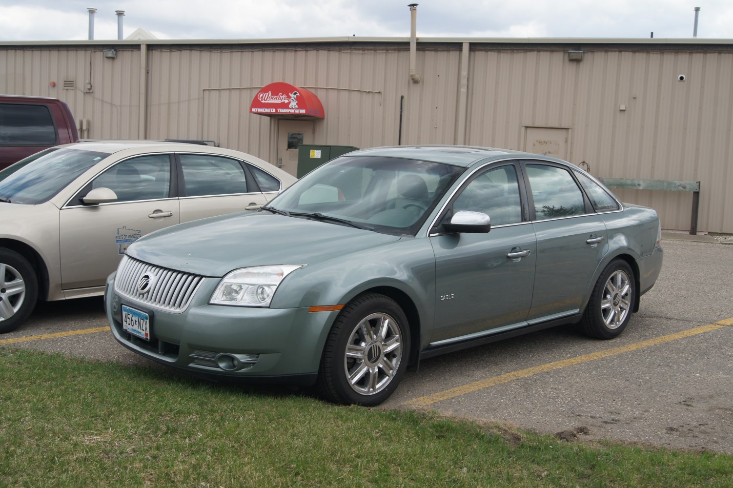 Sedan with chrome grille, alloy wheels, four-door design