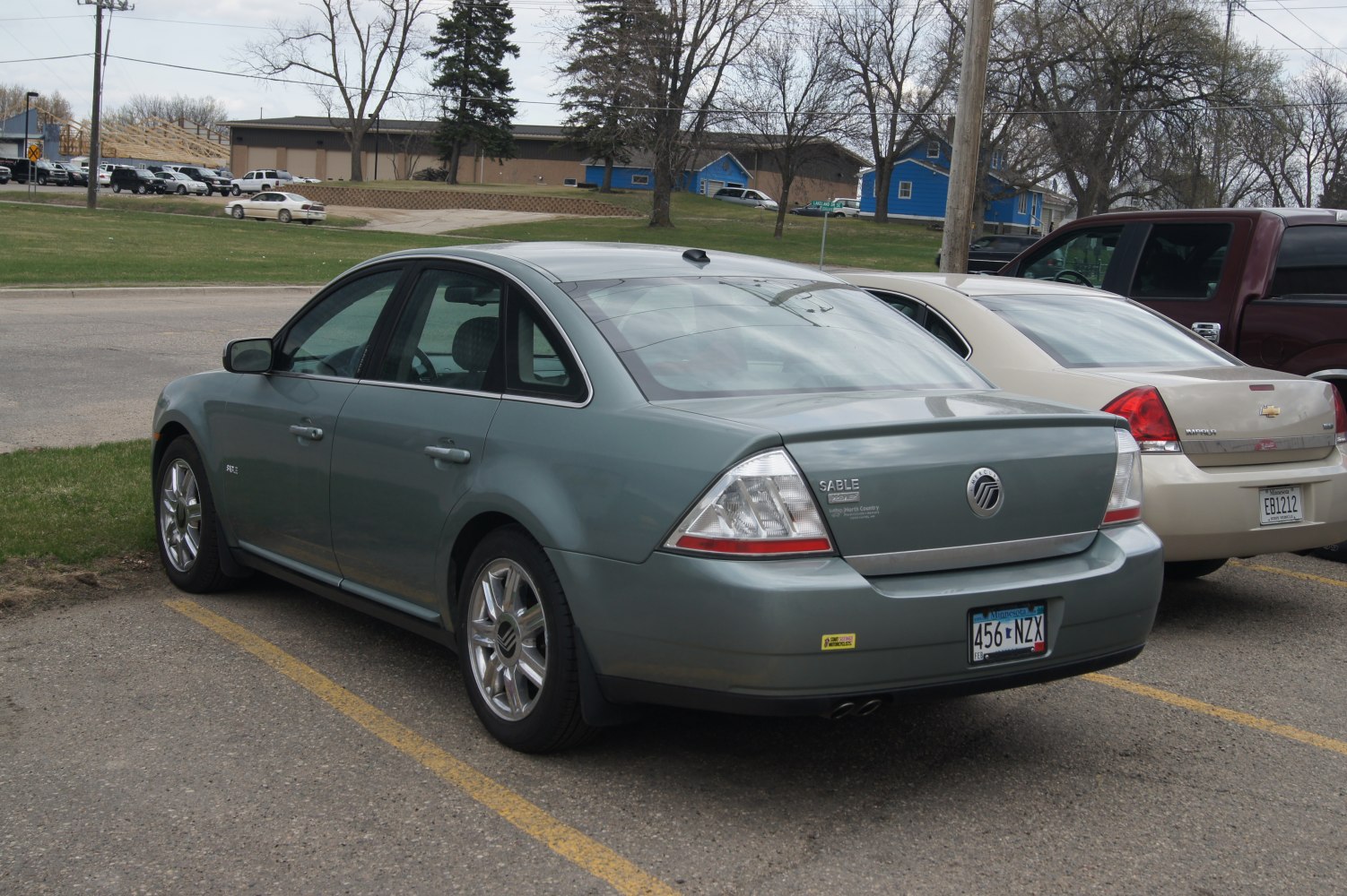 Rear and side view of a sedan with distinct taillights and alloy wheels.