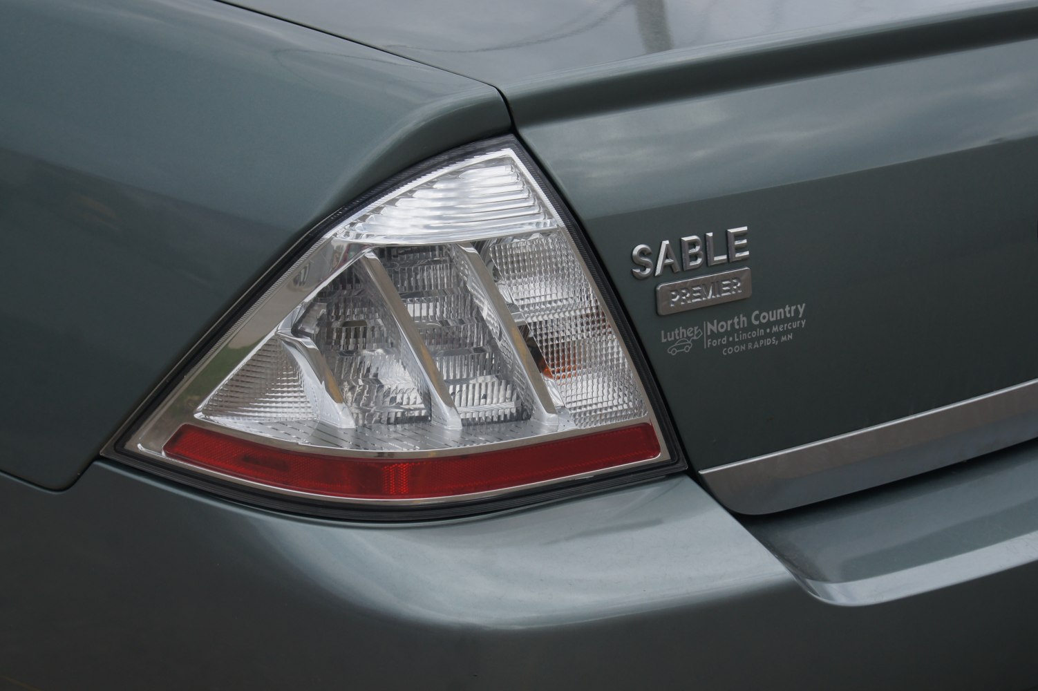 Close-up of a rear taillight and badge on a vehicle