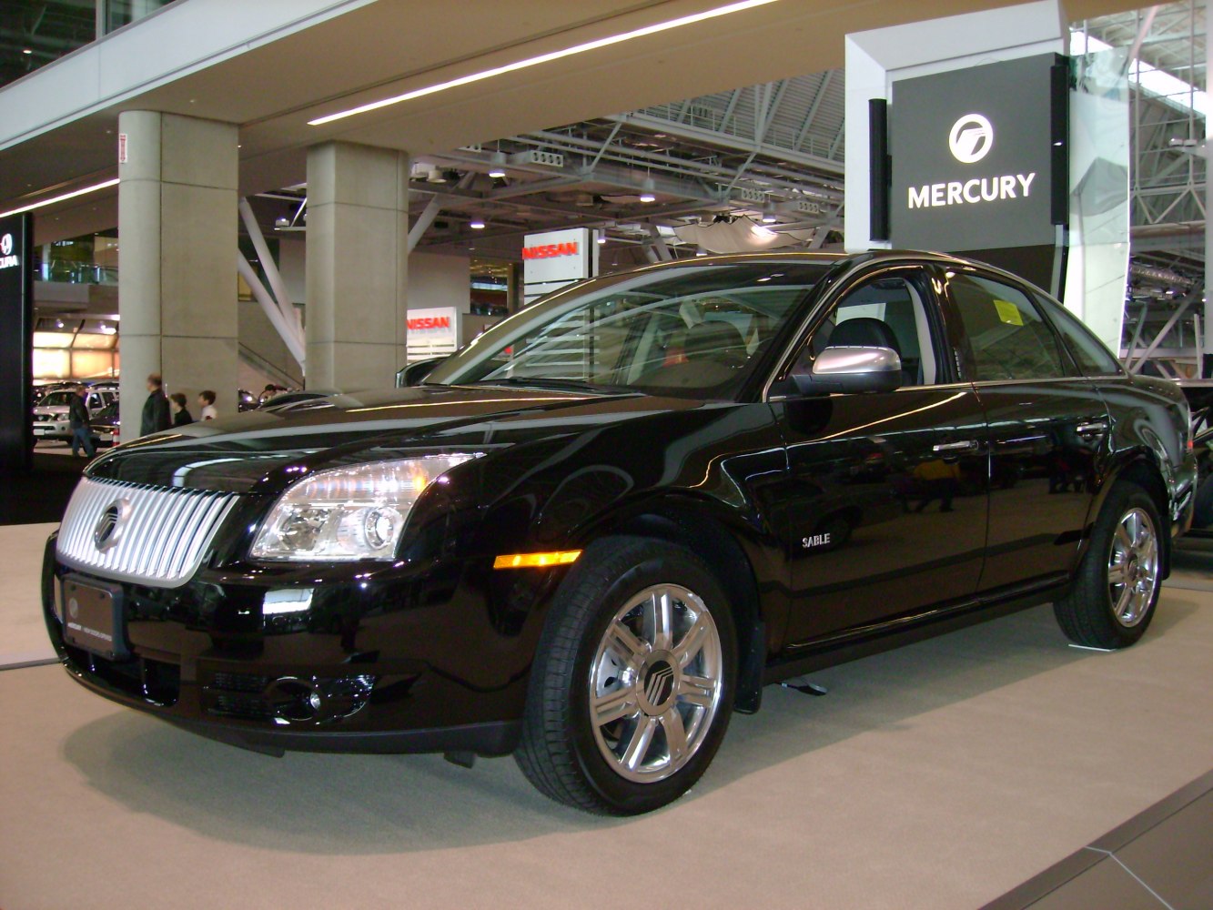 Front-side view of sedan with chrome grille and polished alloy wheels