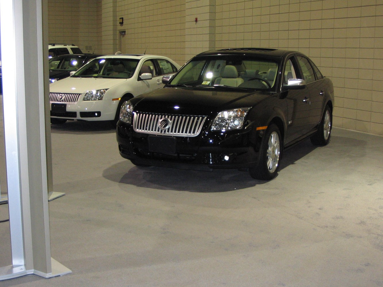 Sedan front grille, headlights, and beige interior seating