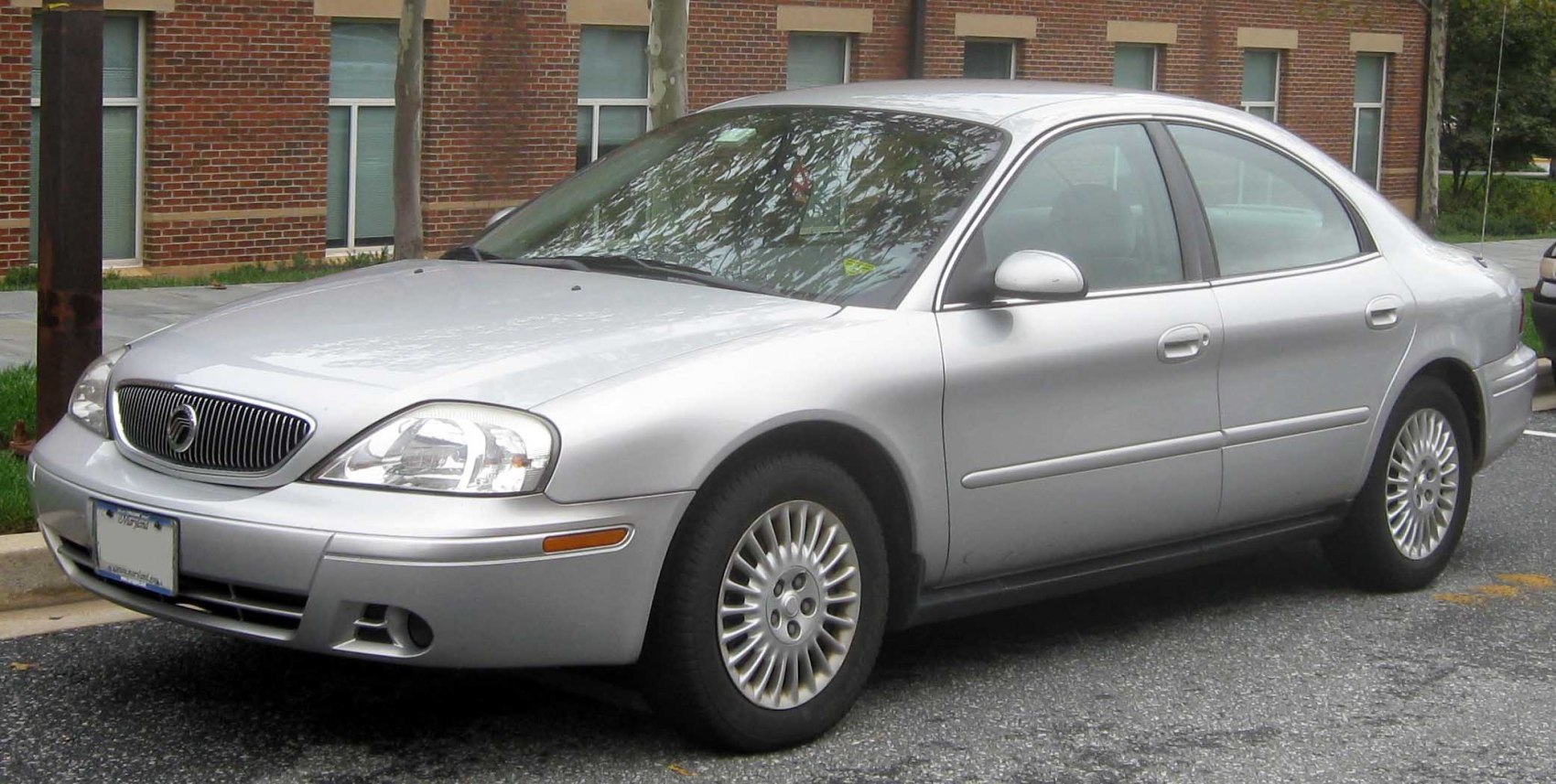 Silver sedan front side view with distinct grille and alloy wheels