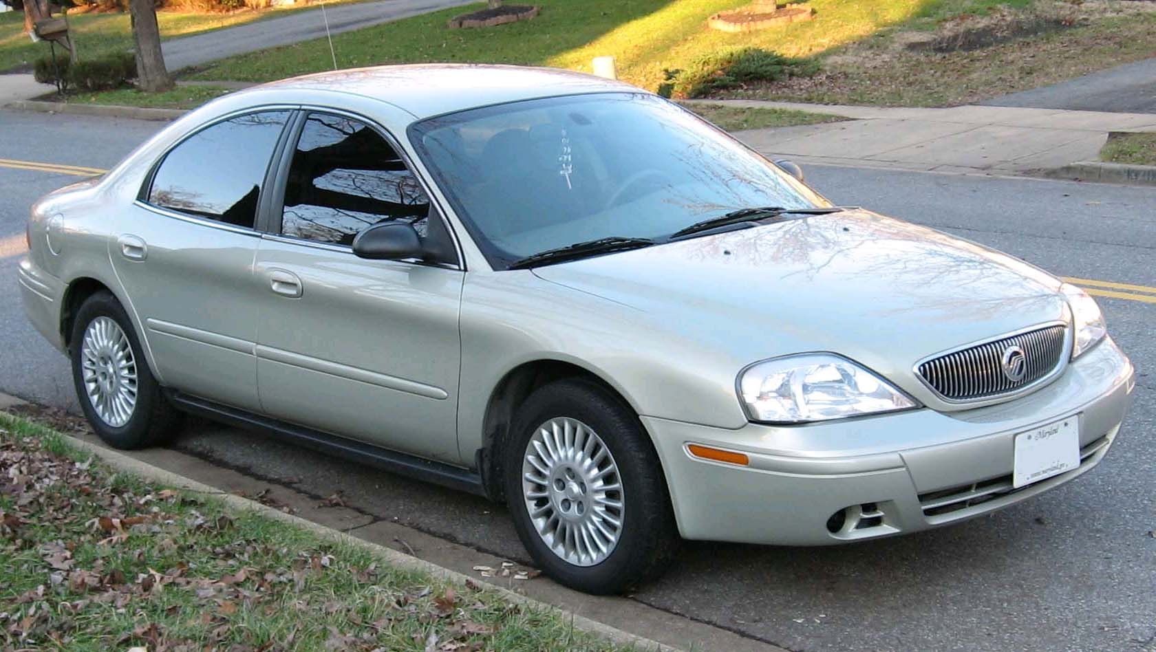Silver mid-2000s sedan with alloy wheels and distinctive front grille