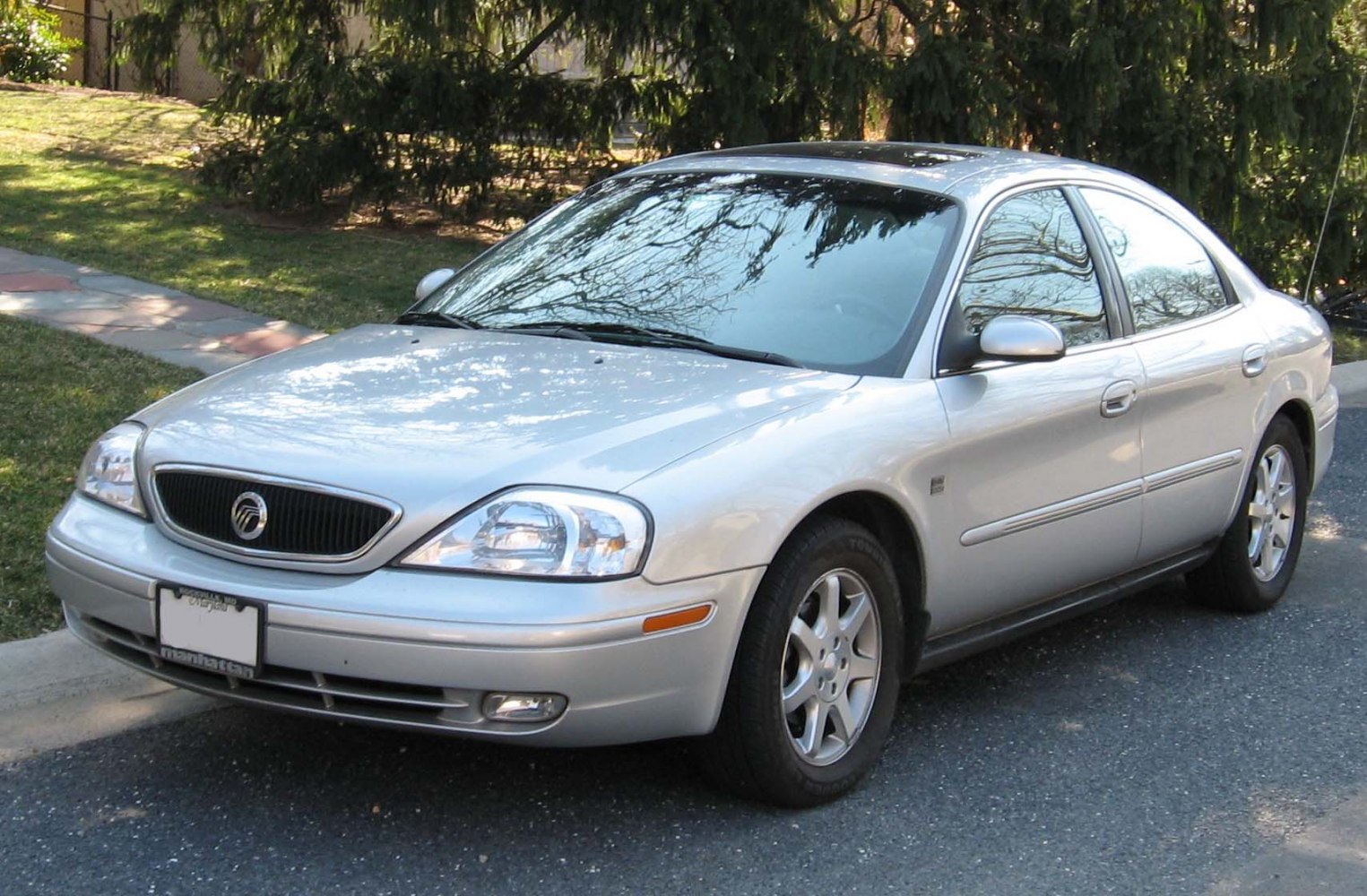 Silver sedan with smooth front design and alloy wheels