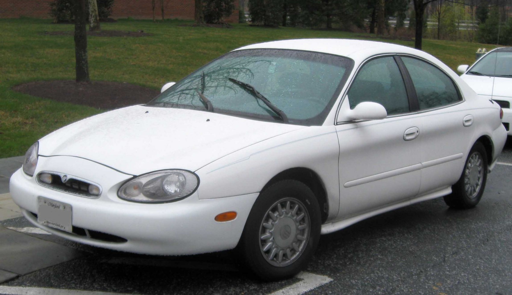 White sedan with oval headlights and distinctive front grille