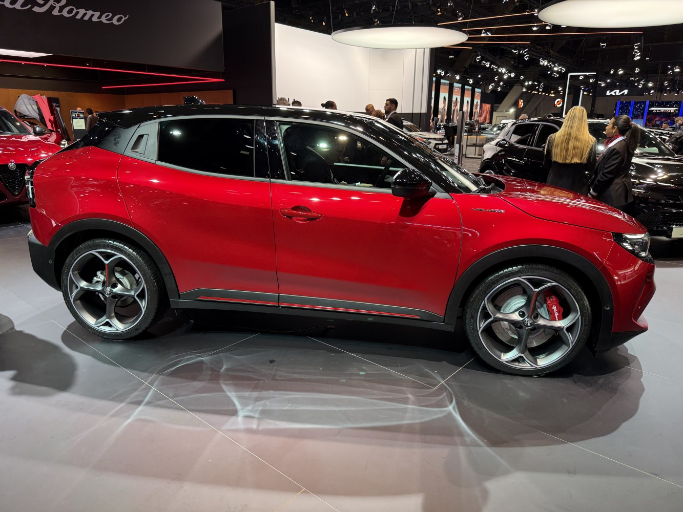 Side profile of sporty compact SUV with black roof and alloy wheels.