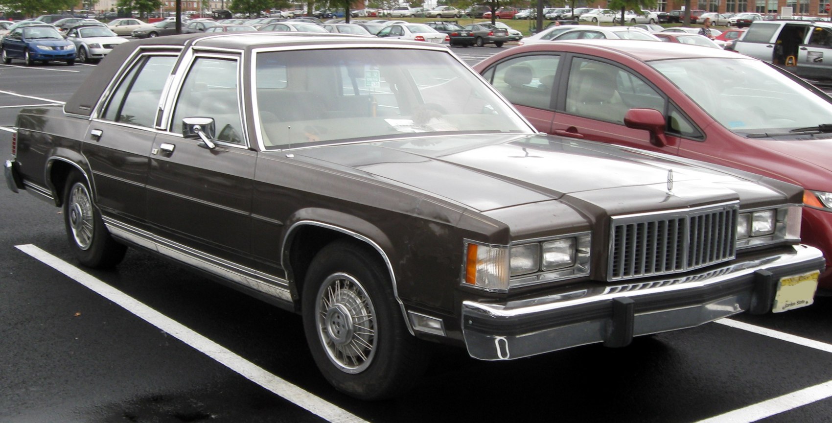 Classic full-size sedan with boxy shape and wire-spoke wheels