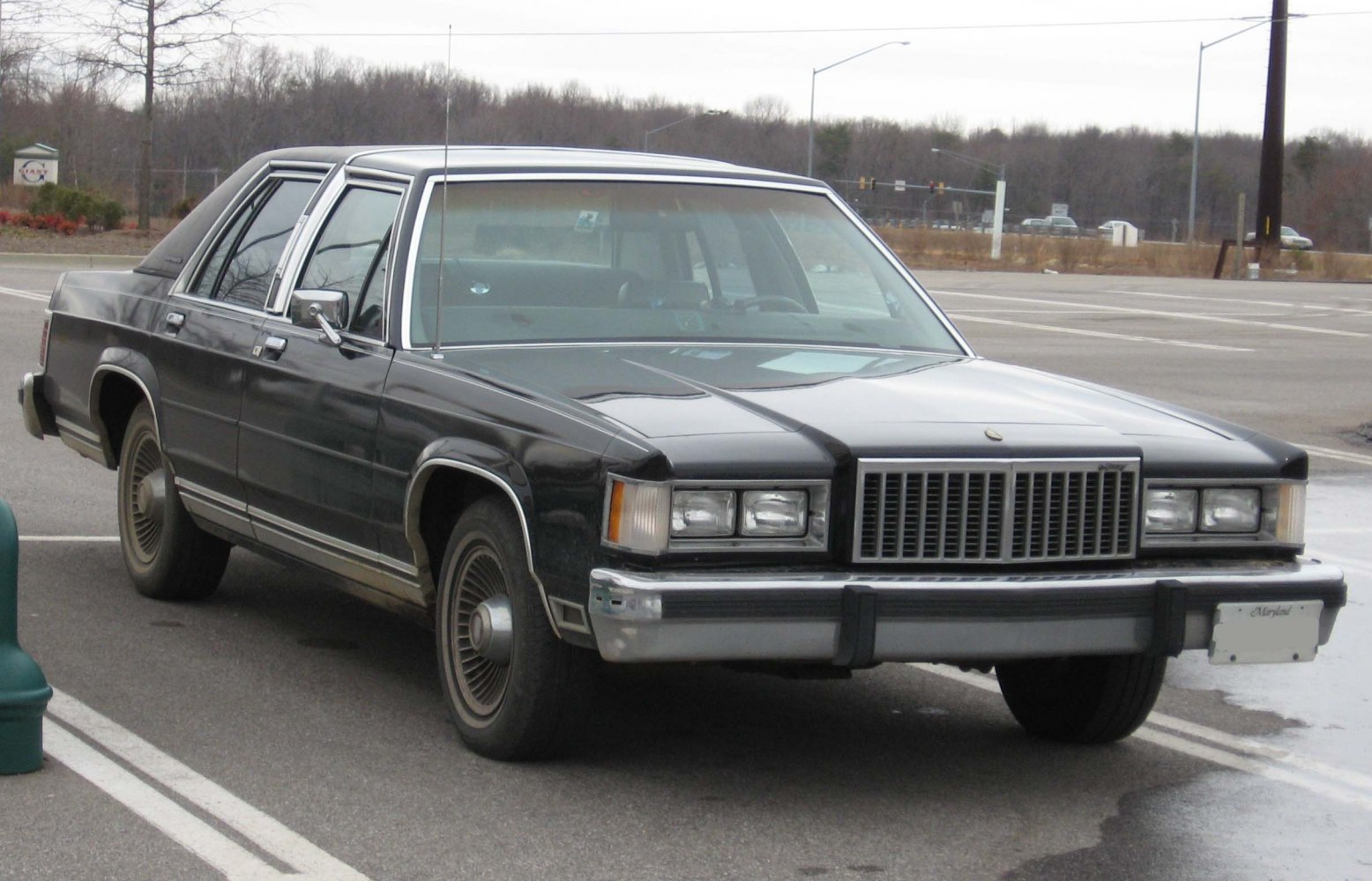Classic vintage sedan featuring square headlights and vertical grille