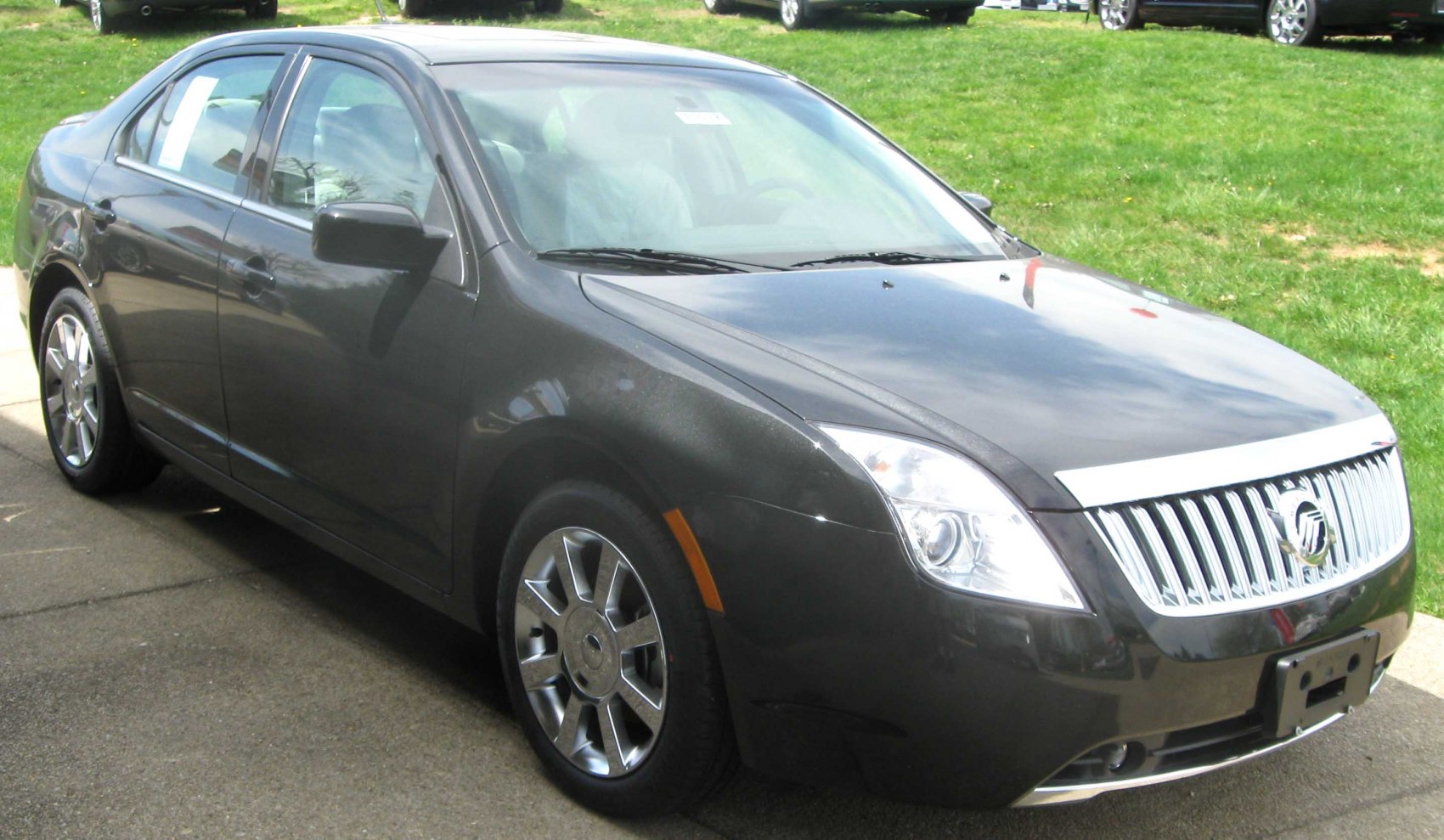Front side view with chrome vertical grille and alloy wheels
