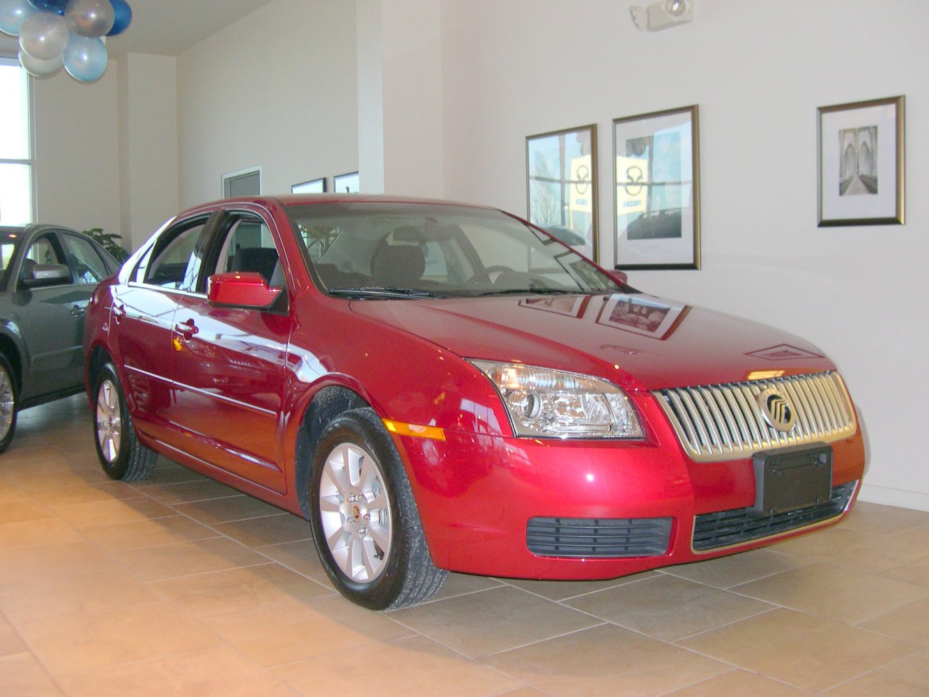 Front grille and headlight detail on a red sedan