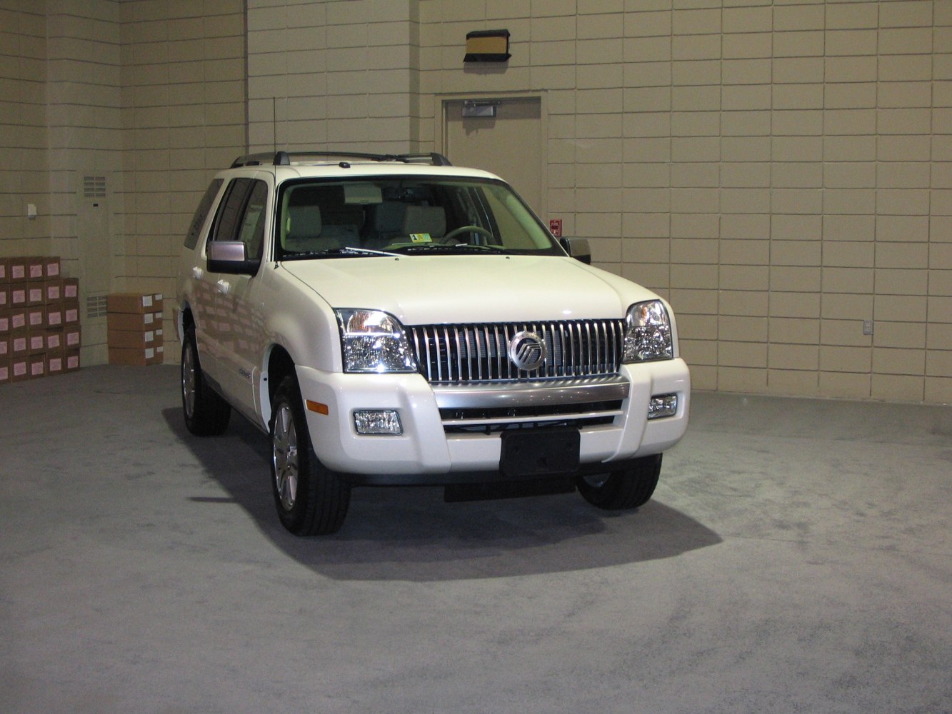 Front view of an SUV with chrome vertical bar grille and integrated headlights
