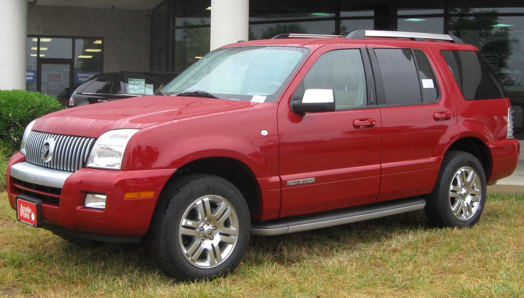 Bold front side profile of red midsize SUV with alloy wheels