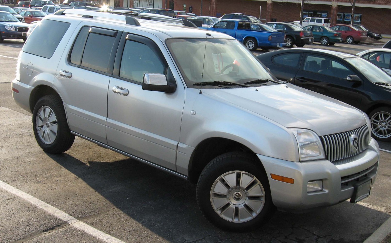 Compact mid-2000s SUV with vertical grille and roof rails