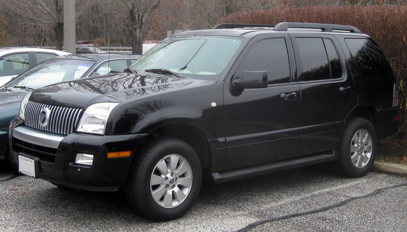 Black mid-size SUV front side view with grille and alloy wheels