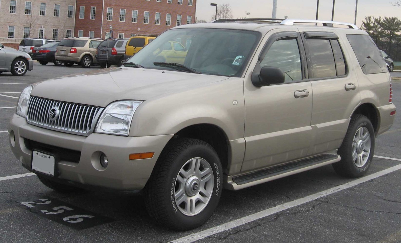Front-side view of beige SUV with grille and running boards