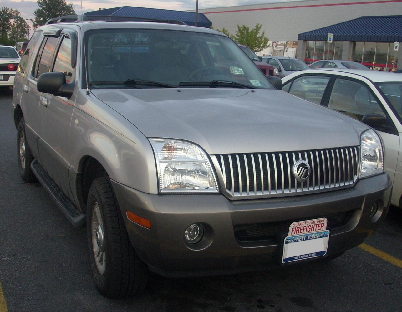 Front grille and headlights of an SUV with fog lights.
