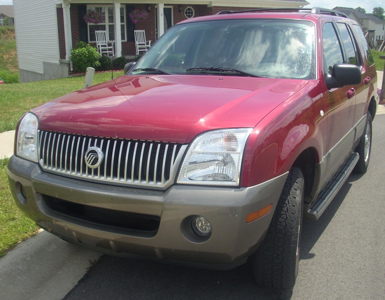 Front view of SUV with chrome vertical grille and clear headlights