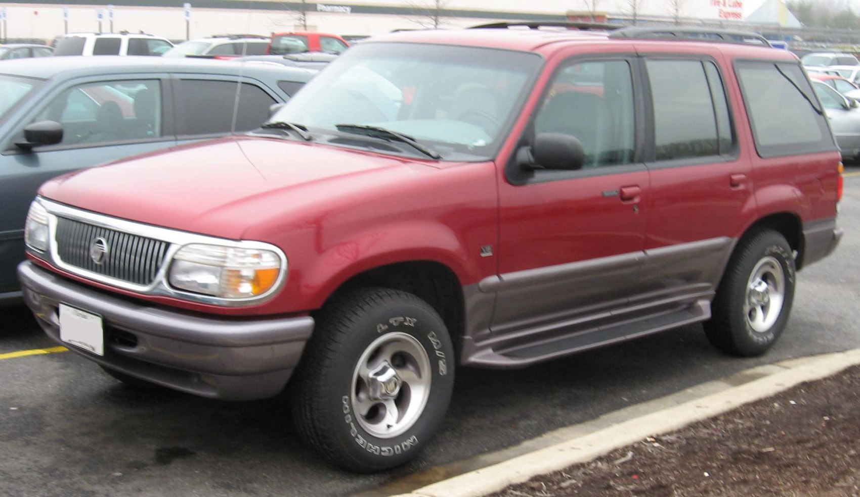 Red and gray two-tone SUV with alloy wheels and classic 90s design